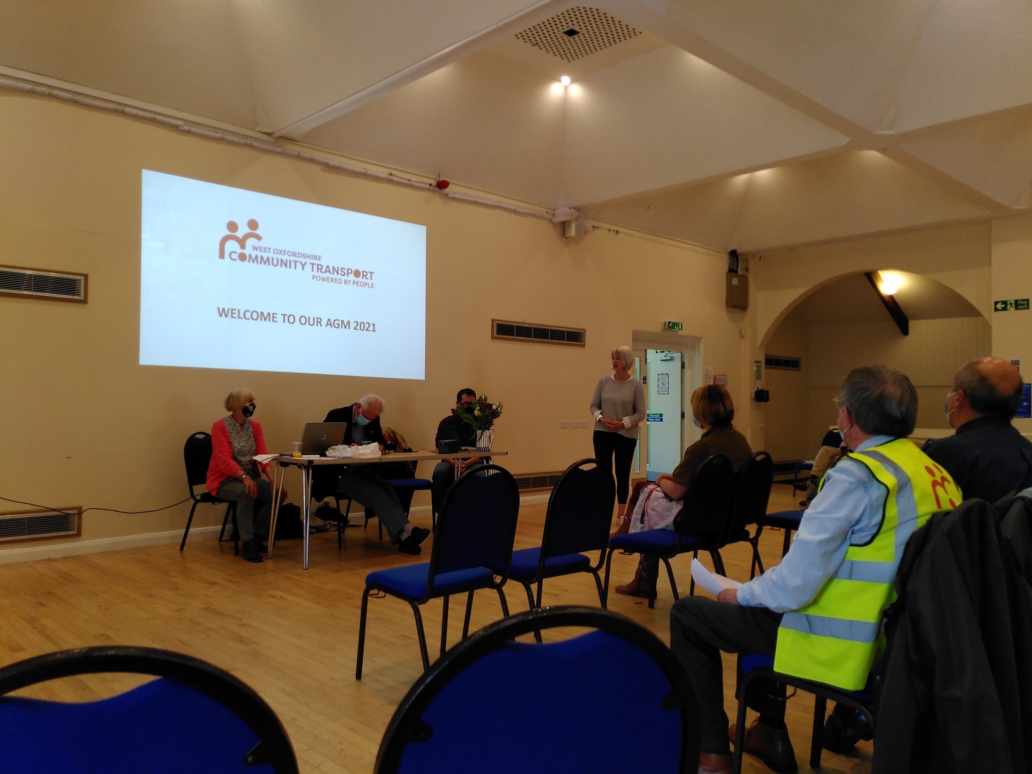 A shot of two members of the Board presenting the 2021 AGM, with guest speaker, OCC Leader Liz Leffman, speaking from the stage.